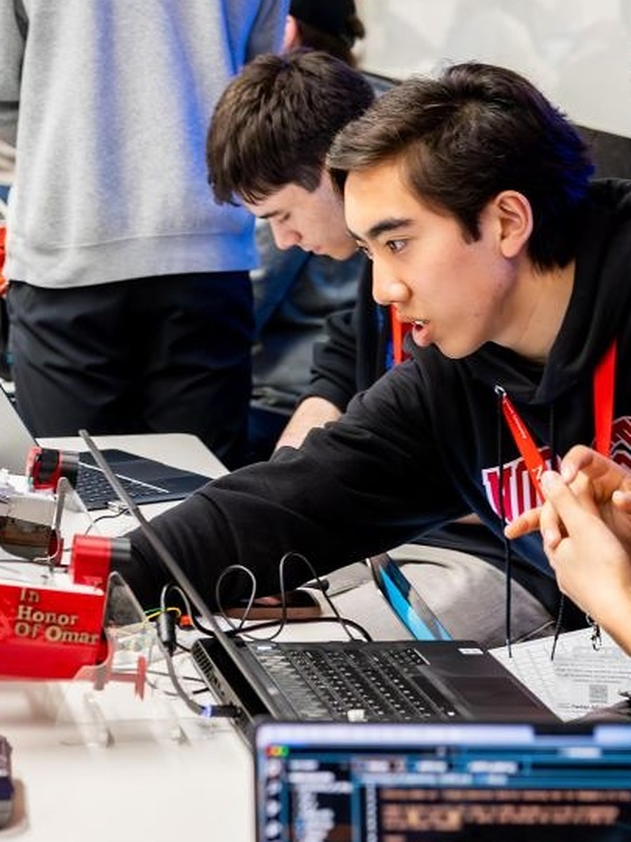 Matthew Hong demoing D.R.E.A.M.S. on a laptop at the Northeastern project showcase